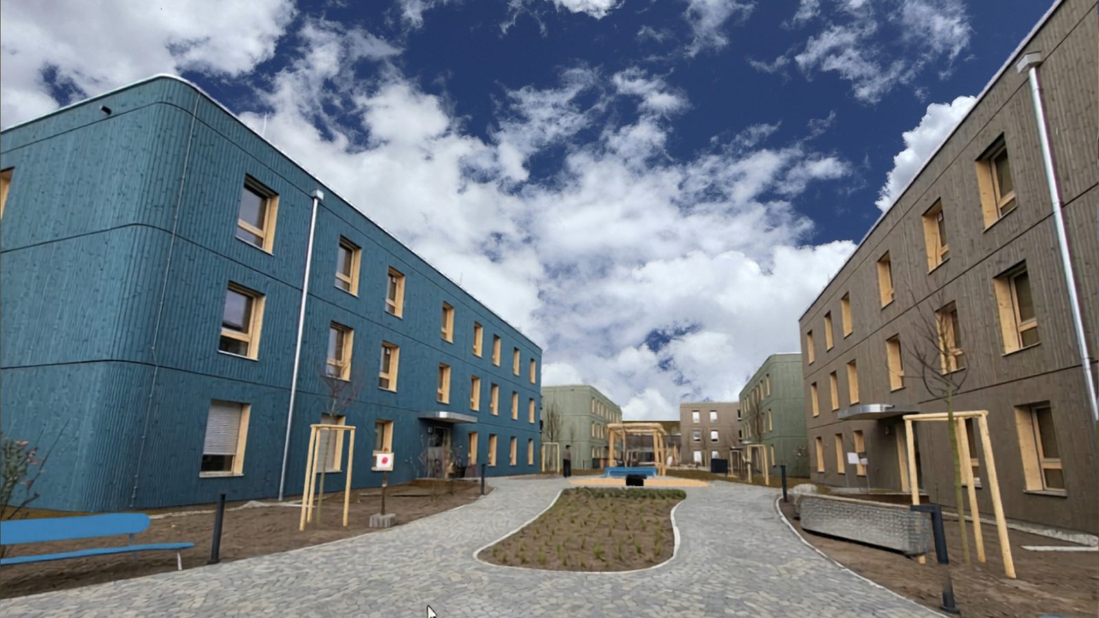 WoodRocks Wohnquartier Mannheim – fünf Holzmodulgebäude mit farbigen Holzfassaden um einen begrünten Innenhof